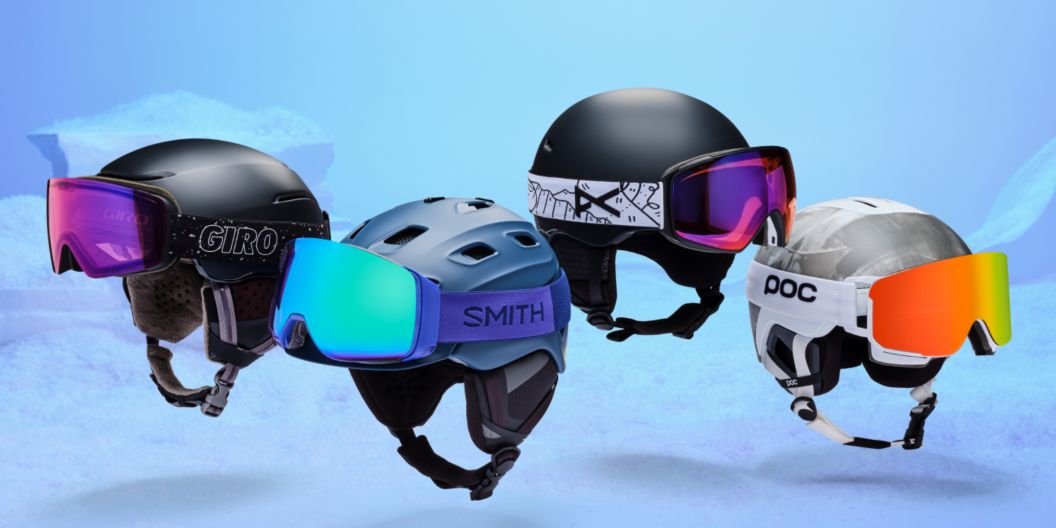 Four helmets with colorful goggles on them floating over a drab background.
